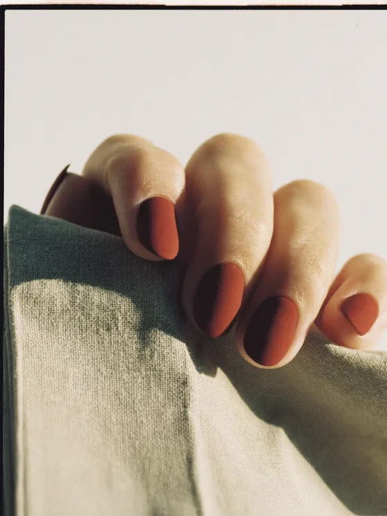 Nails in a fully matte burnt terracotta